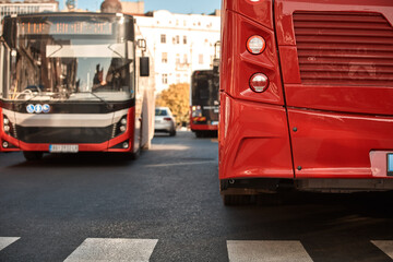 Red bus for public transportation parked on a station.