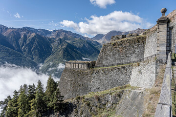 Forte delle Valli ramparts over low clouds in Valchisone valley, Fenestrelle, Italy