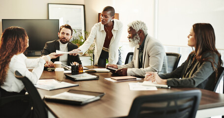 Documents, handout and meeting with business people in boardroom of office for coaching or training. Collaboration, diversity and workshop with professional employee group in corporate workplace