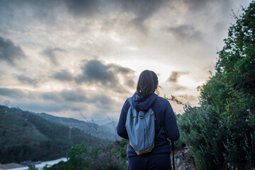 Hiker contemplating nature at sunset.