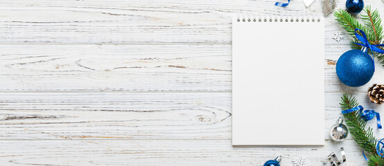 Christmas blank greeting card mock-up scene. Creative layout made of Christmas tree branches and paper card note. Flat lay. Nature New Year concept