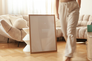 50x70 cm Frame Mockup held by a person in a modern apartment