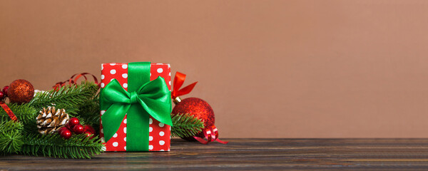 New Year Christmas mood, gift box, branches of a christmas tree, New Year decorations on a colored background