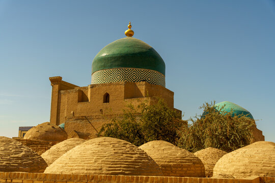 A large green dome sits atop a building with a blue roof