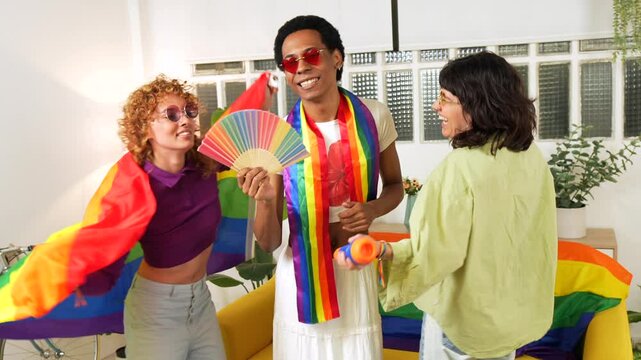 Multi-ethnic and gender diverse lgbt friends singing karaoke during pride party at home