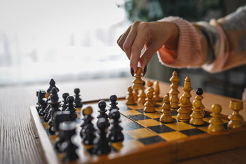 Close-up of woman hand move chess piece in strategic board game © Lana Milanovic