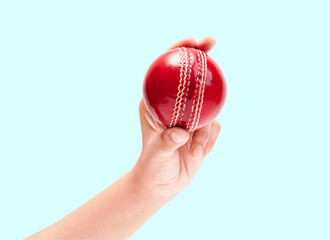 Shiny Red Test Match Leather Stitch Cricket Ball In Women Hand Closeup Photo