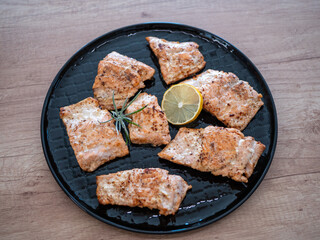 Baked salmon fillets and cod in butter. A healthy lunch of fish full of vitamins and healthy fats.