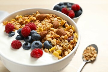 Delicious granola with berries and yogurt on the table