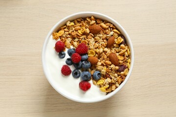 Delicious granola with berries and yogurt on the table