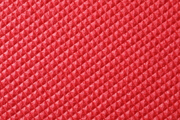 Red textured background, close up