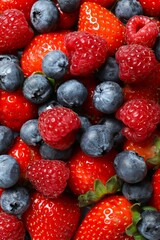 Obraz premium Different fresh ripe berries, top view