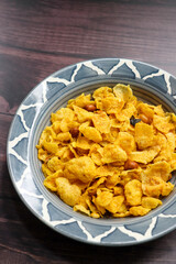 Maka Chivda is a Maharashtrian snack made with popped corn kernels, roasted peanuts, curry leaves, and spices. It offers a mix of sweet, salty, and spicy flavors, perfect for festive times or a crunch