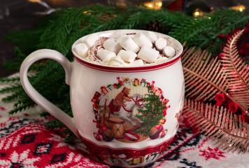 A mug of hot chocolate with whipped cream and marshmallow	