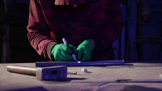 Specialist makes mark on block for notch punching in shop