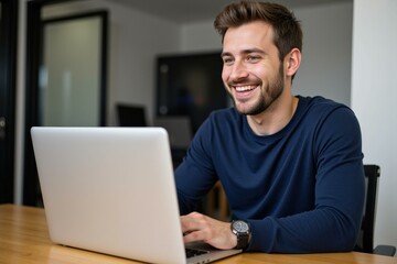 Happy Young Man Working on Laptop in Modern Office Space, Ideal for Web Design, Marketing, and Freelance Concepts