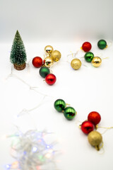 Capture the magic of the holidays with this captivating image of colorful Christmas ornaments nestled amongst twinkling fairy lights. 
