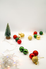 Capture the magic of the holidays with this captivating image of colorful Christmas ornaments nestled amongst twinkling fairy lights. 