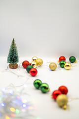 Capture the magic of the holidays with this captivating image of colorful Christmas ornaments nestled amongst twinkling fairy lights. 