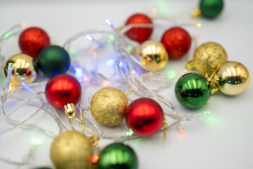 Capture the magic of the holidays with this captivating image of colorful Christmas ornaments nestled amongst twinkling fairy lights. 