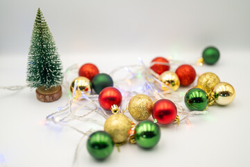 Capture the magic of the holidays with this captivating image of colorful Christmas ornaments nestled amongst twinkling fairy lights. 