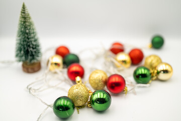 Capture the magic of the holidays with this captivating image of colorful Christmas ornaments nestled amongst twinkling fairy lights. 