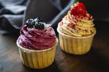 Cupcakes with cream and fresh berries