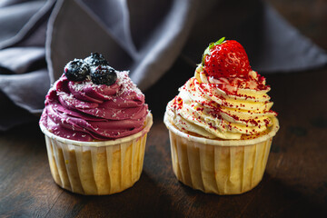 Cupcakes with cream and fresh berries