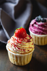 Cupcakes with cream and fresh berries