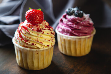 Cupcakes with cream and fresh berries
