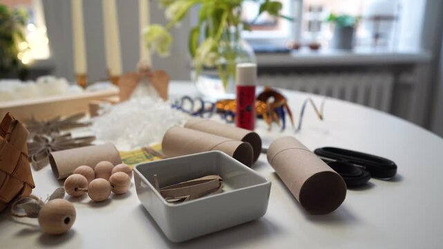 Holiday craft materials in natural materials and neutral colors on table