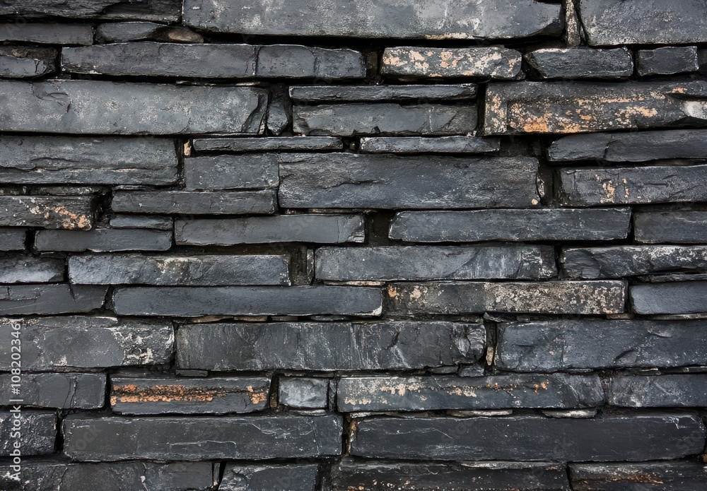 Poster textured slate wall with dark gray stones displaying unique patterns for architectural and interior 