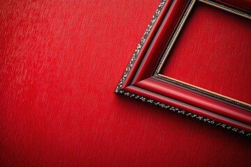 Fototapeta premium A bright red wall features a decorative picture frame in the center