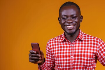 A man holds his cell phone in a red and white checkered shirt, perfect for everyday use