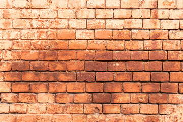 Fototapeta premium Aged red brick wall with signs of wear and tear. texture background