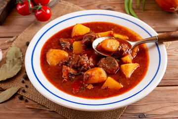 Goulash soup with beef, potatoes and sweet pepper. Stew of meat and vegetables, flavored with paprika. Hungarian cuisine.
