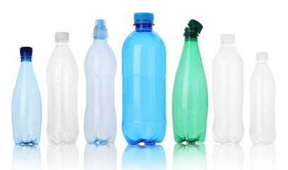 Many different plastic bottles on white background