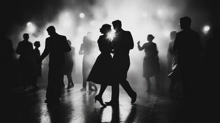 Silhouetted dancers in a smoky, atmospheric setting.
