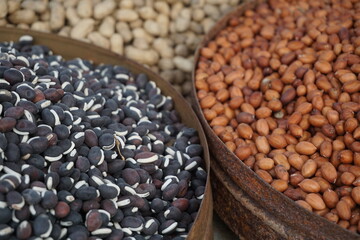 Roasted peanut and bean are being sold on a food cart, A heap of organically produce bean and peanut, Mixed peanuts and bean are selling by a street vendor