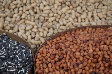 Roasted peanut and bean are being sold on a food cart, A heap of organically produce bean and peanut, Mixed peanuts and bean are selling by a street vendor