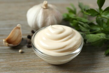 Bowl with mayonnaise and ingredients for cooking on the table 