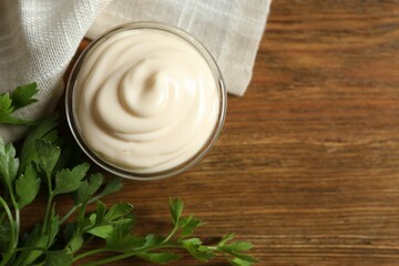Bowl with mayonnaise and ingredients for cooking on the table 