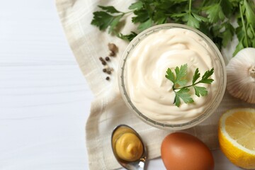 Bowl with mayonnaise and ingredients for cooking on the table 