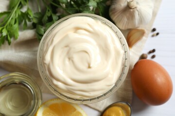 Bowl with mayonnaise and ingredients for cooking on the table 