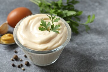 Bowl with mayonnaise and ingredients for cooking on the table 