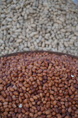 Roasted peanut and bean are being sold on a food cart, A heap of organically produce bean and peanut, Mixed peanuts and bean are selling by a street vendor