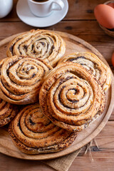 Fototapeta premium Bun rolls with poppy seeds on table. Homemade bakery concept for background and wallpaper.