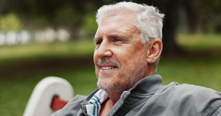 Mature man, thinking and outdoor for happiness, reflection and memory with nostalgia in park. Male person, smile and relax for break or peace in nature for calm, environment and fresh air on weekend