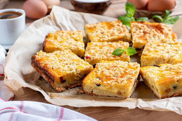 Homemade cottage cheese pie. Rustic grated cake bars on a board