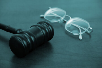 Judge gavel and female eyeglasses on table. Women judge concept.